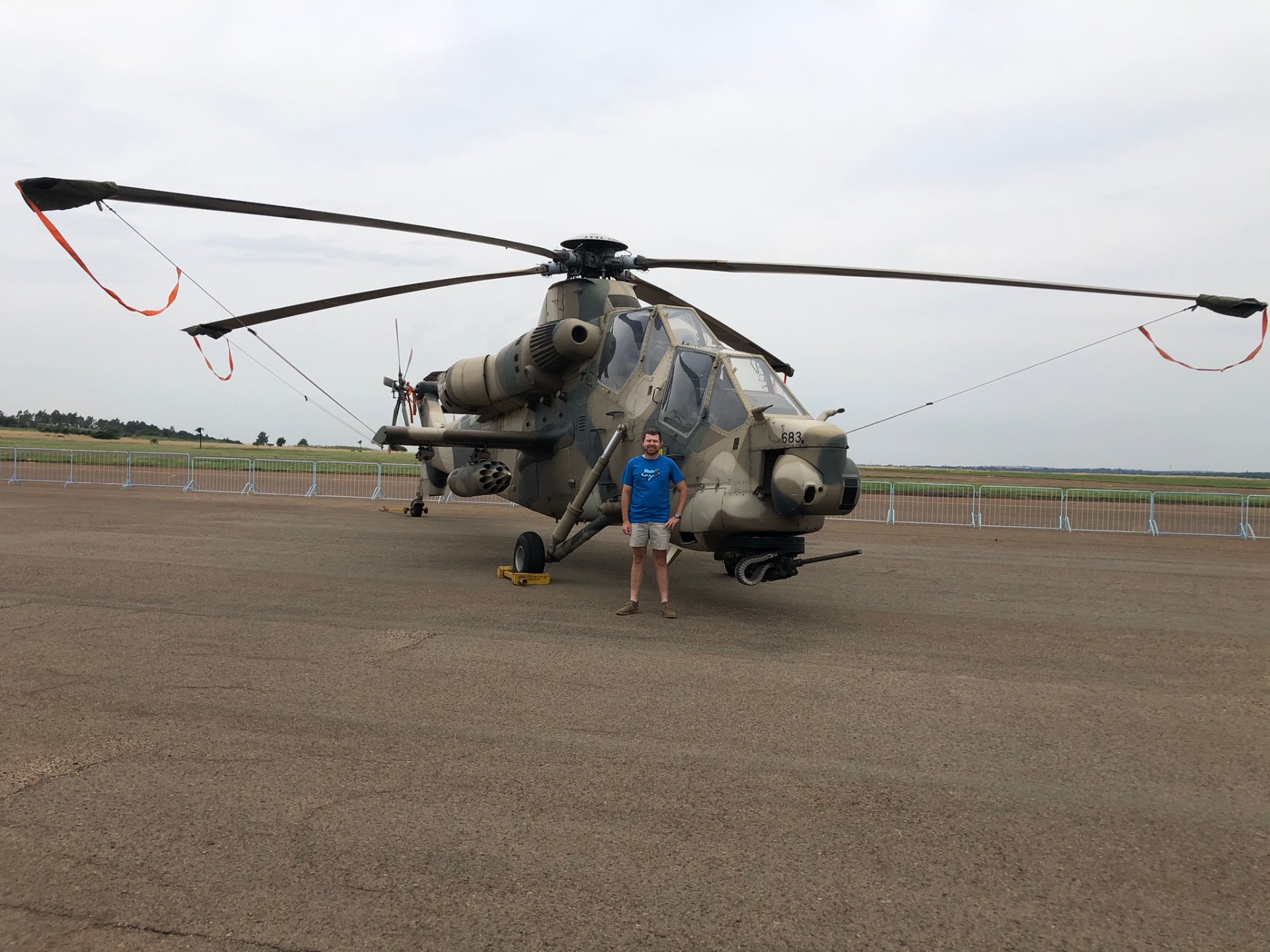 Angelo standing in front of a military display helicopter at an airshow