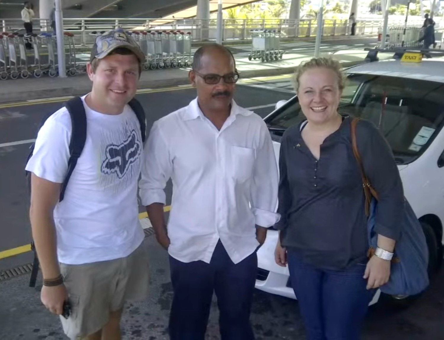 Angelo with his mum and dad at the airport