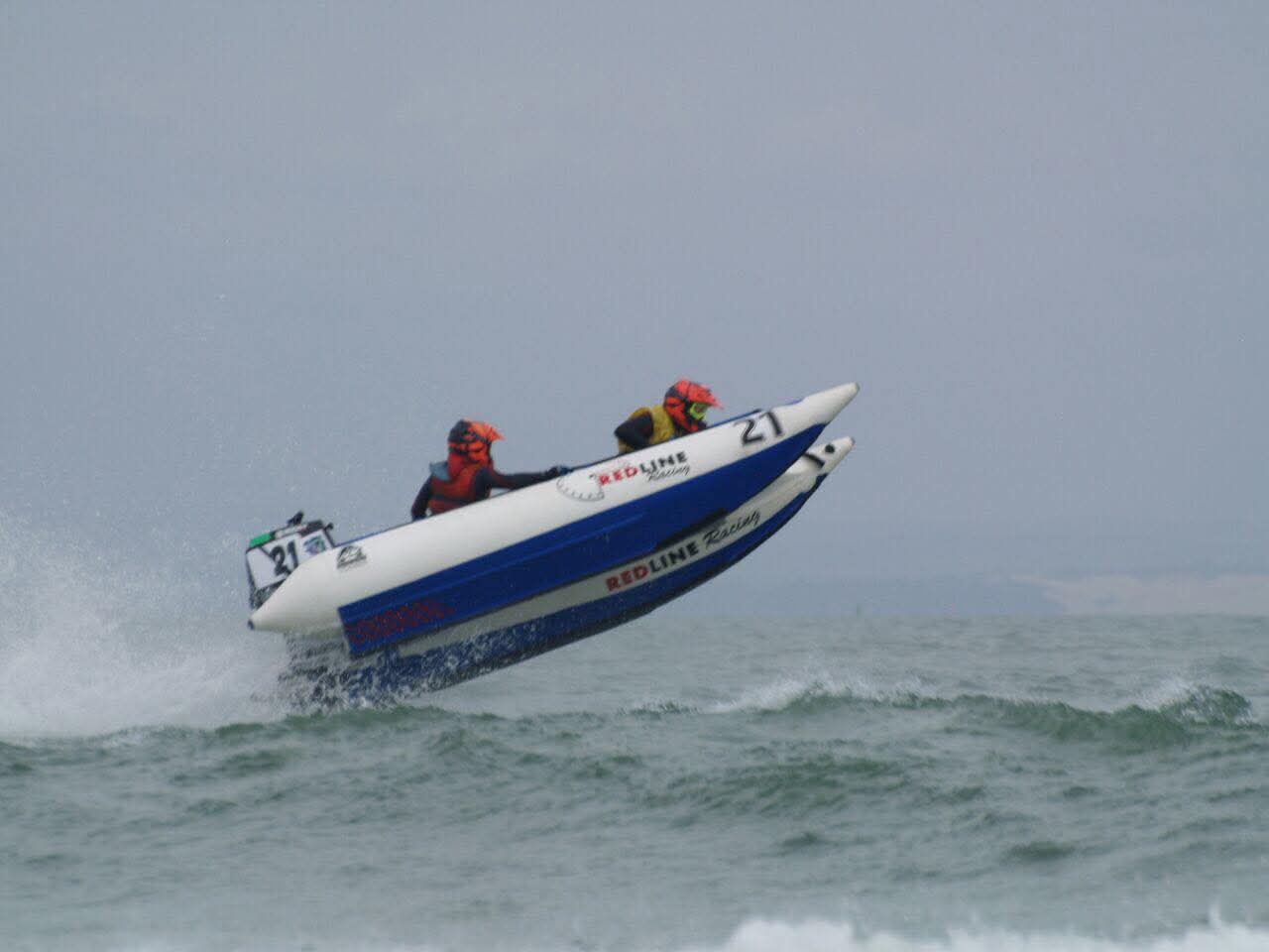 Angelo's racing boat flying above the swell in rough seas