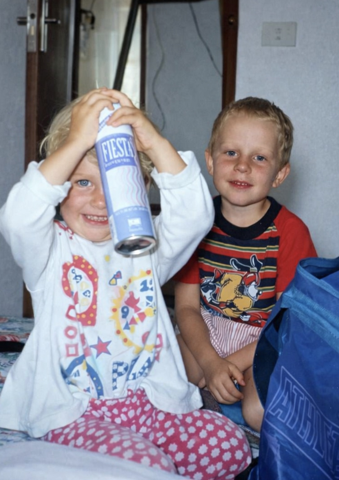 Angelo and his sister as toddlers playing together indoors
