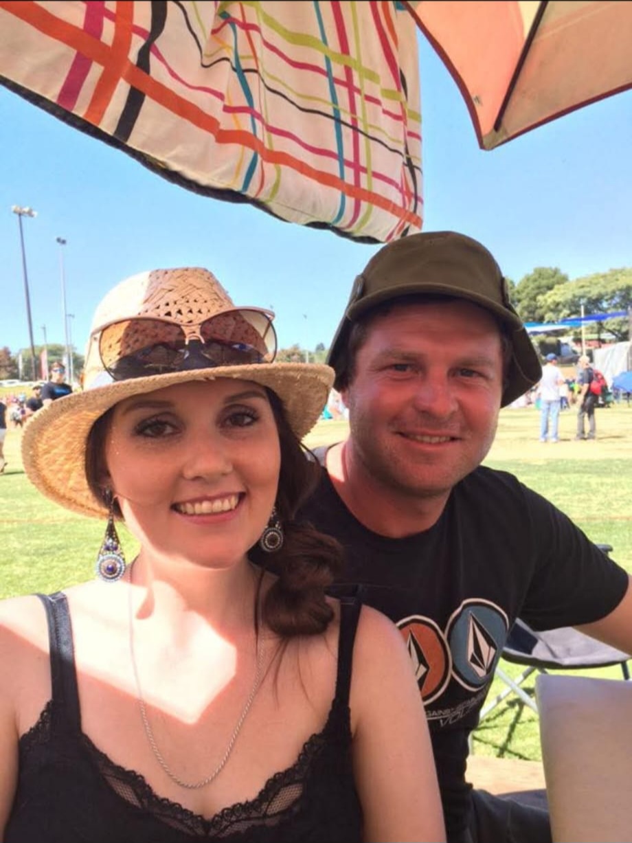 Angelo and a friend taking a selfie under the umbrellas at an outdoor festival