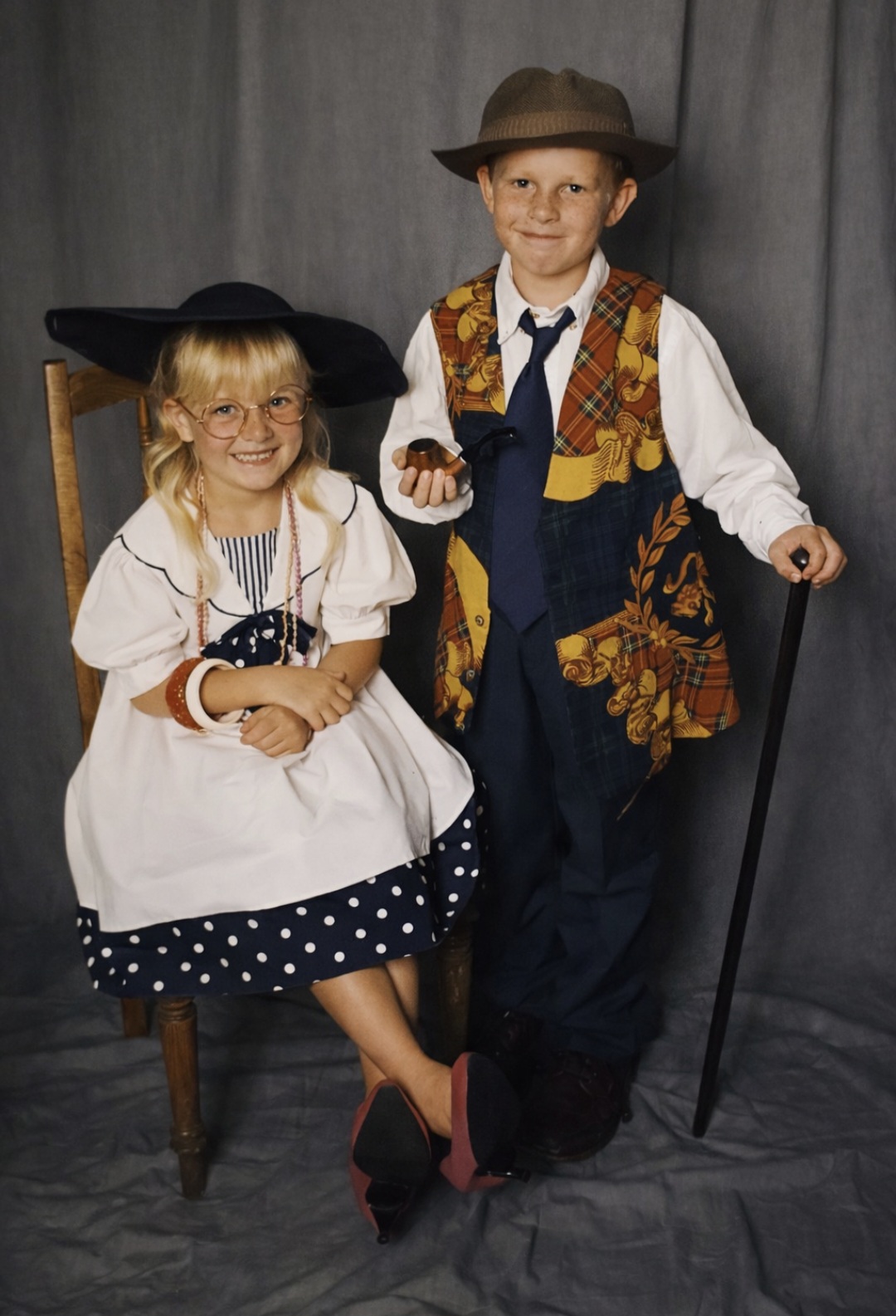 Angelo and his sister dressed up in old-fashioned costumes for a studio photo