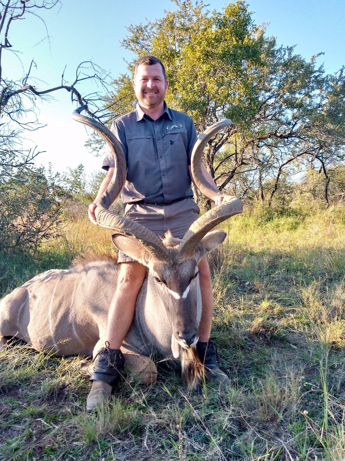 Angelo behind a large kudu bull in the bushveld