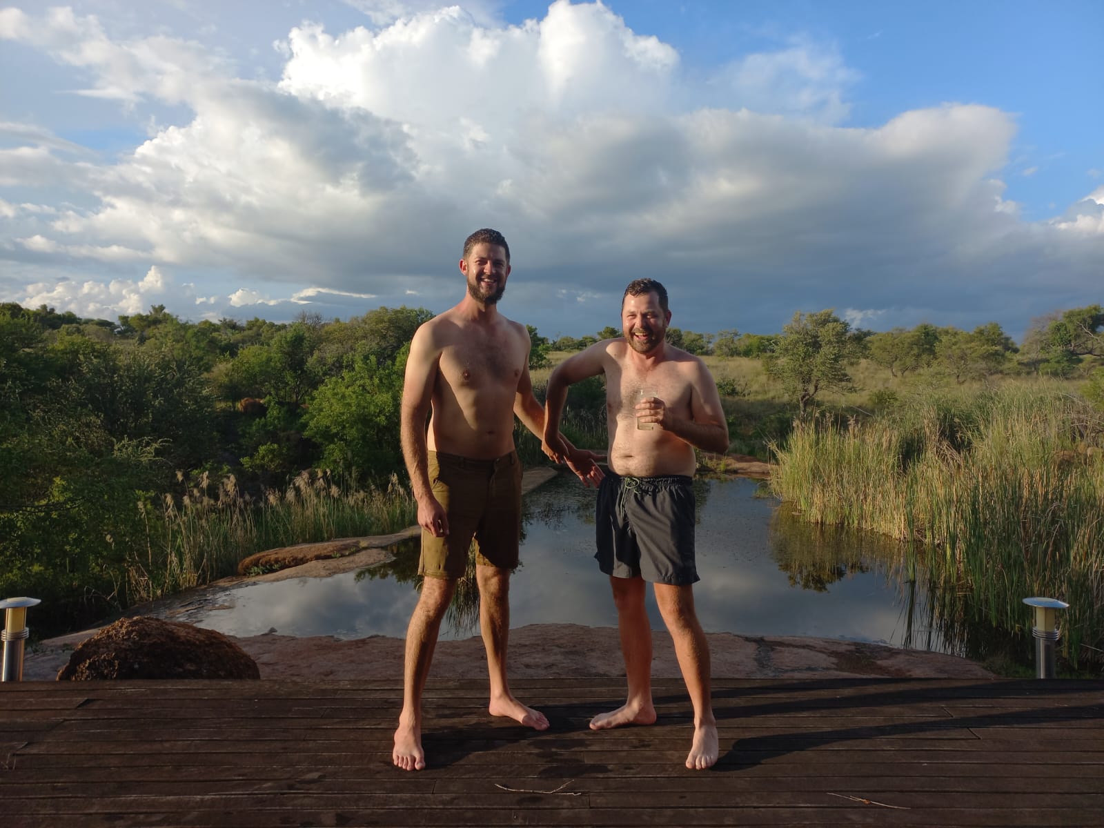 Angelo and his best friend laughing together on the deck above the water