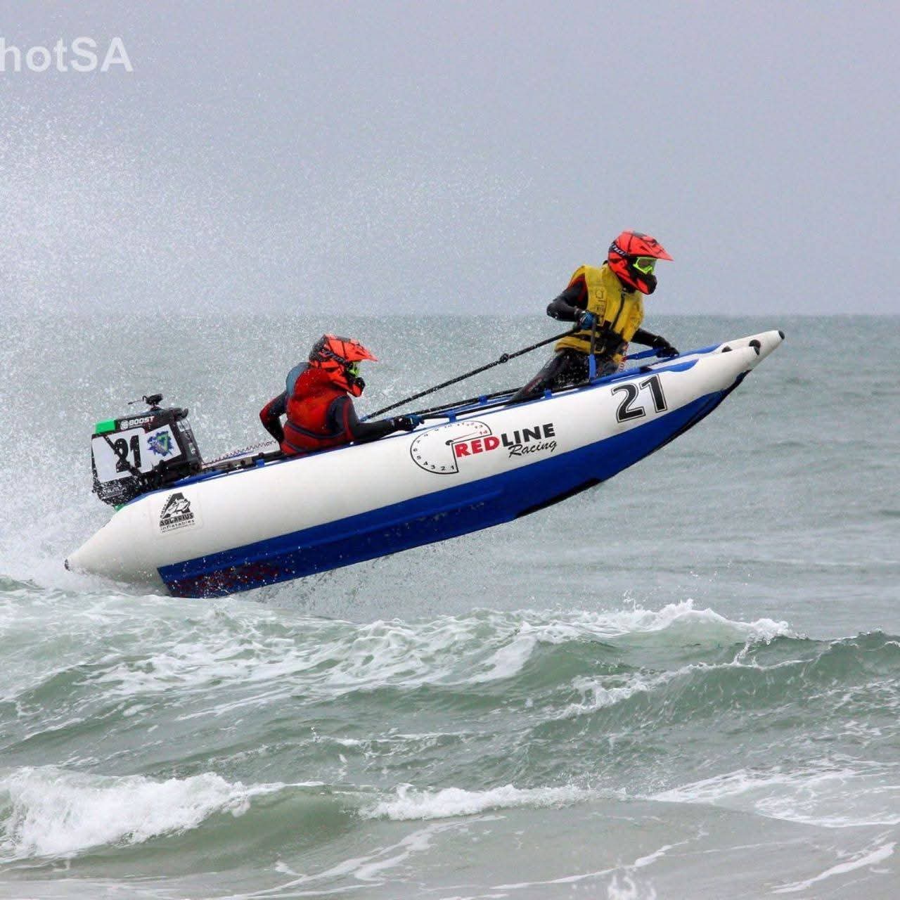 Angelo racing an inflatable boat airborne over ocean waves