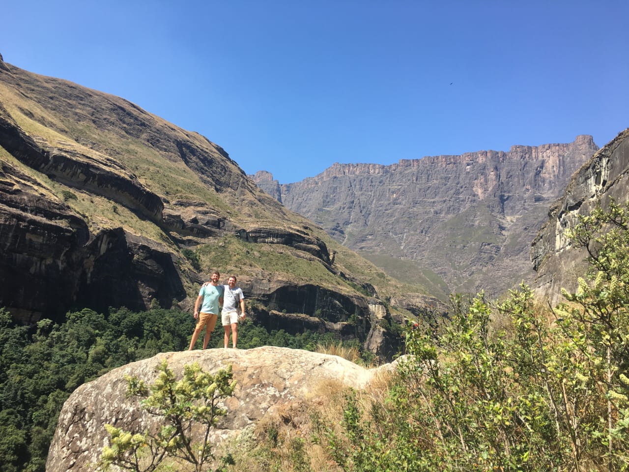 Angelo and a friend on a rock with the great sandstone cliffs behind them