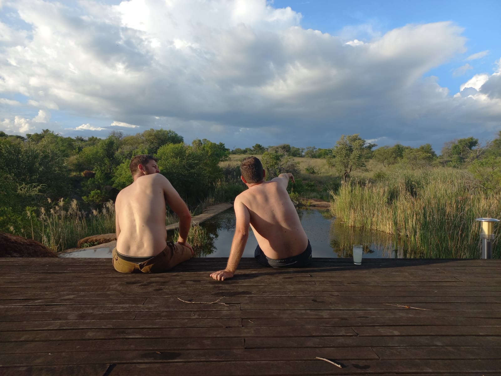 Angelo and his best friend sitting on the deck, taking in the view over the water
