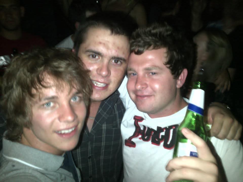 Three friends posing together on a night out