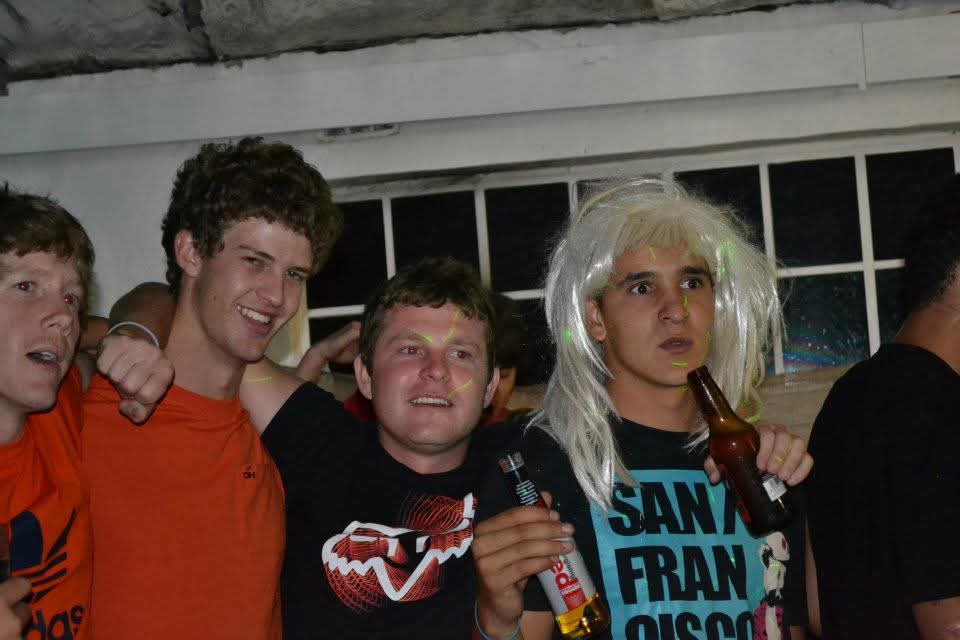 Angelo and friends celebrating together at a fancy-dress party