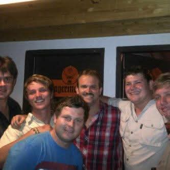 A group of friends smiling together at a pub