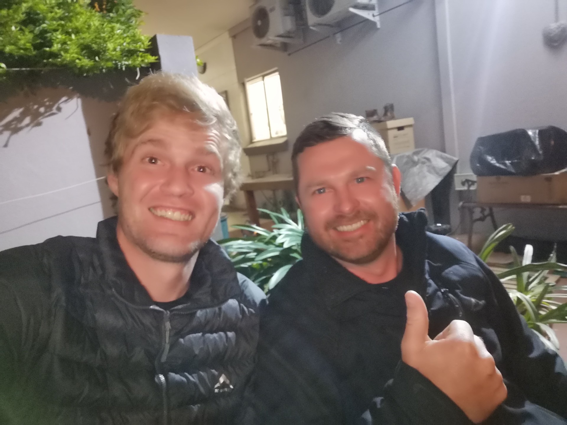 Two friends smiling in a courtyard selfie